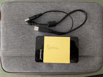 Hard drive with post-it note that says "broken"